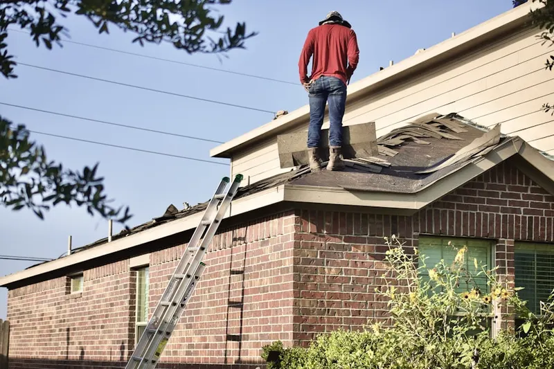 Professional roofer working on a residential roof in Slab City